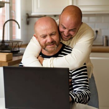 front-view-smiley-men-with-laptop